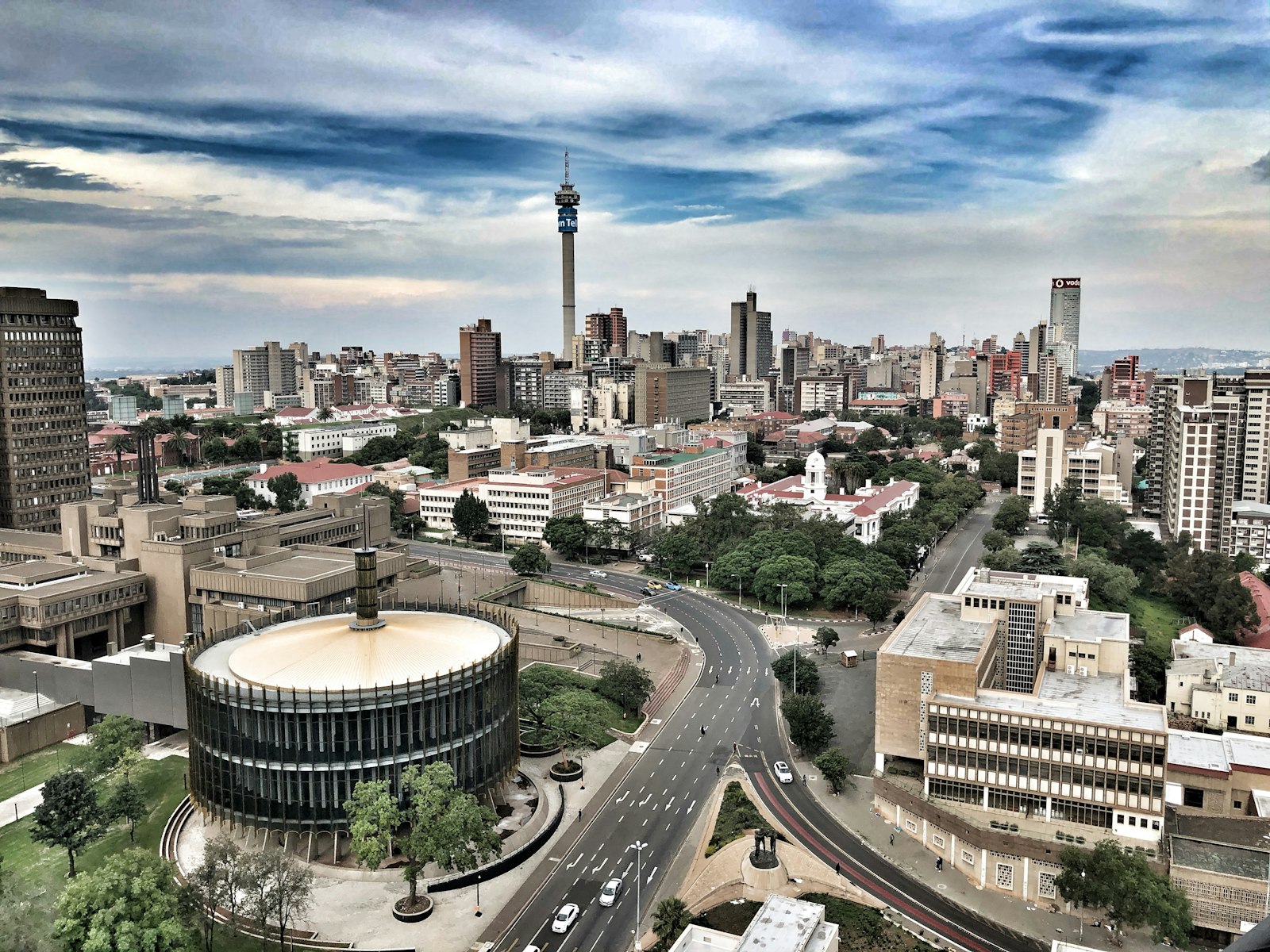 The Johannesburg skyline under a wide sky, with the Hillbrow Tower on the horizon